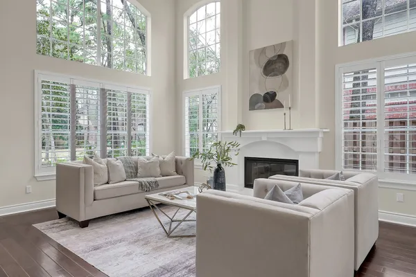 a view of a dining room with furniture a chandelier and wooden floor
