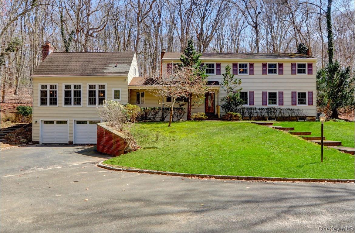 a view of a house with a yard and sitting area