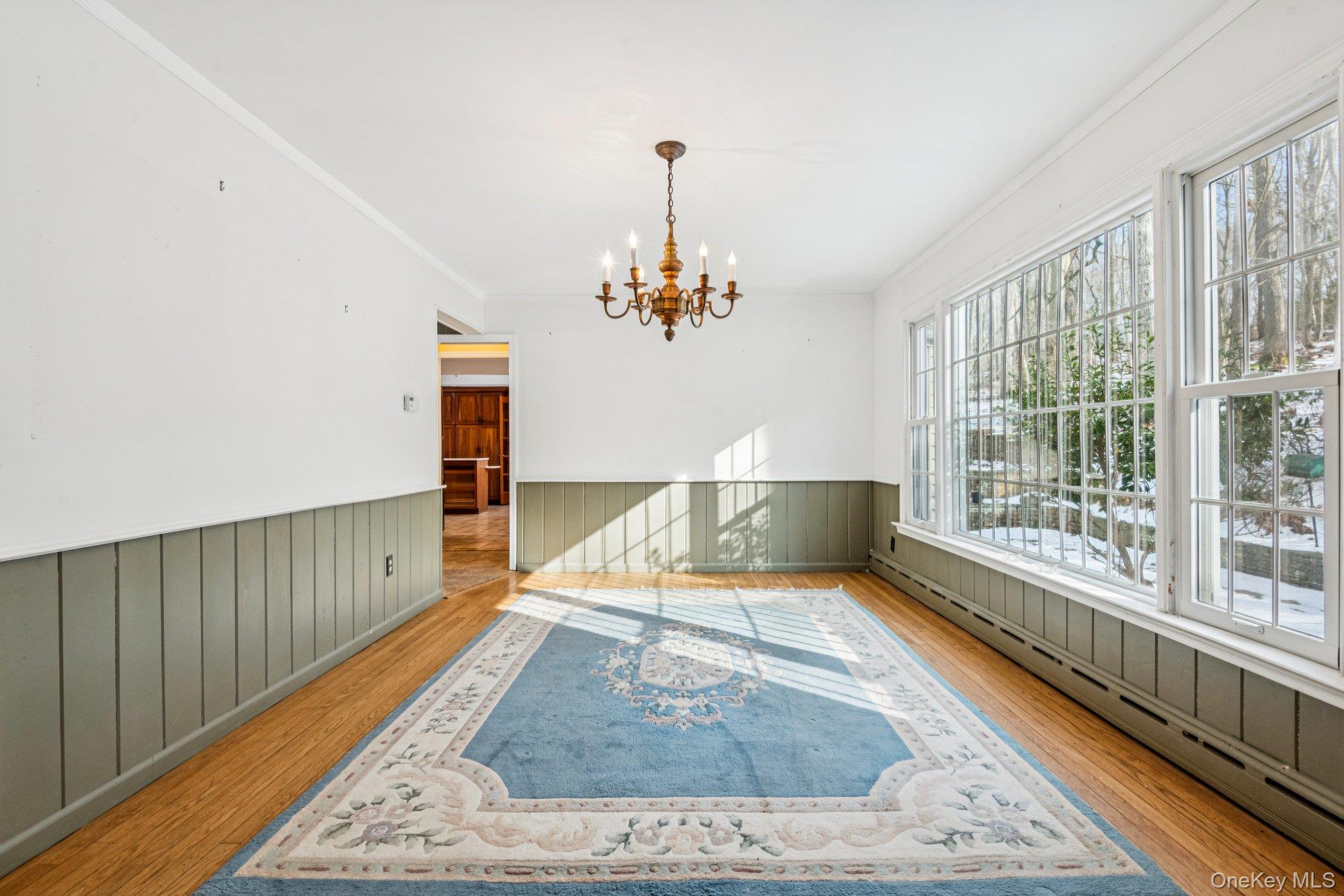 1 Spring Hollow Road St. James, NY 11780 - Photo 12 of 30 a view of a room with wooden floor chandelier and windows