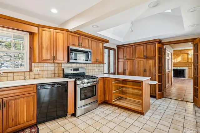 a kitchen with a refrigerator a stove a sink and a microwave