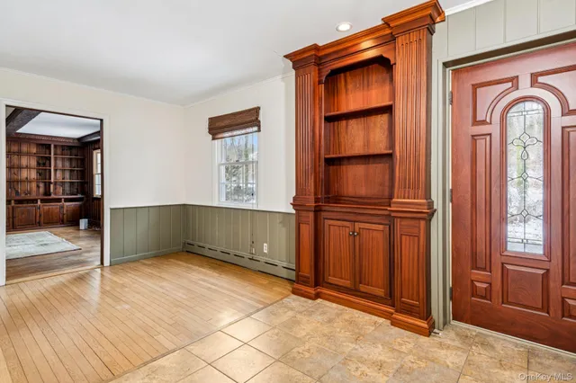 a view of hallway with stairs and wooden floor