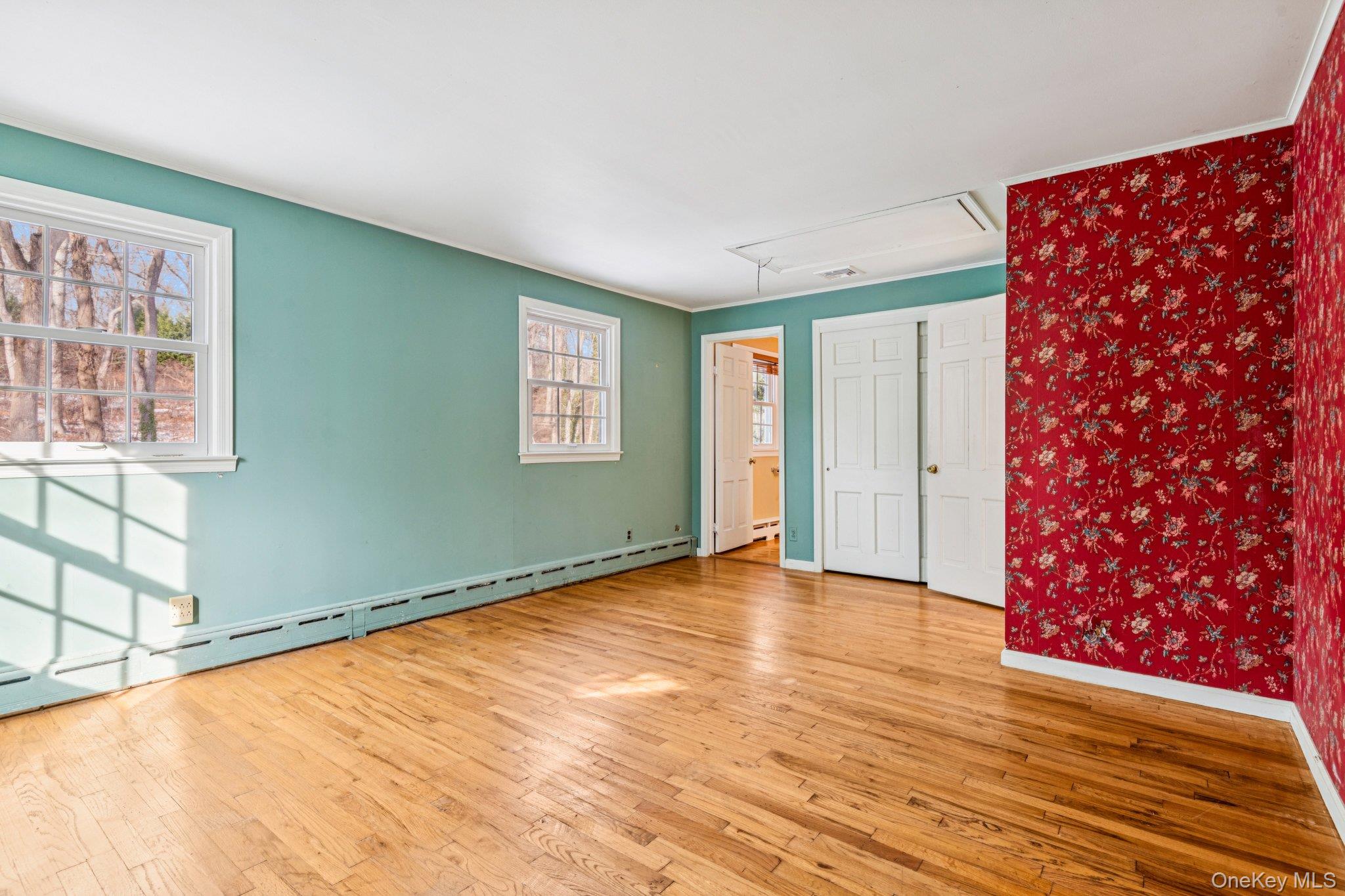 1 Spring Hollow Road St. James, NY 11780 - Photo 20 of 30 a view of an empty room with window and wooden floor