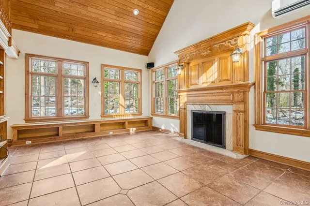 a view of an empty room with a fireplace and a large window