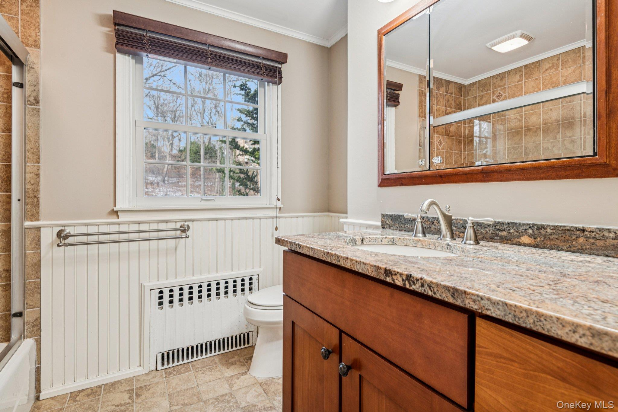 1 Spring Hollow Road St. James, NY 11780 - Photo 24 of 30 a bathroom with a granite countertop sink and a window