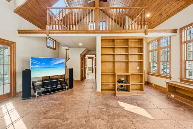a view of a livingroom with furniture and a window