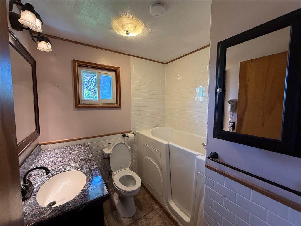 105 Ridgeview Drive Salix, PA 15952 - Photo 19 of 25 a bathroom with a granite countertop sink and a mirror
