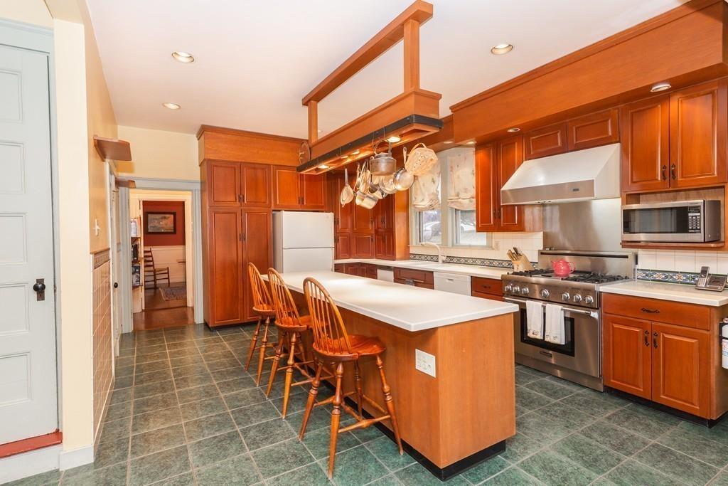 33 Robbins Road Arlington, MA 02476 - Photo 18 of 36 a kitchen with stainless steel appliances a sink a counter top space and a window