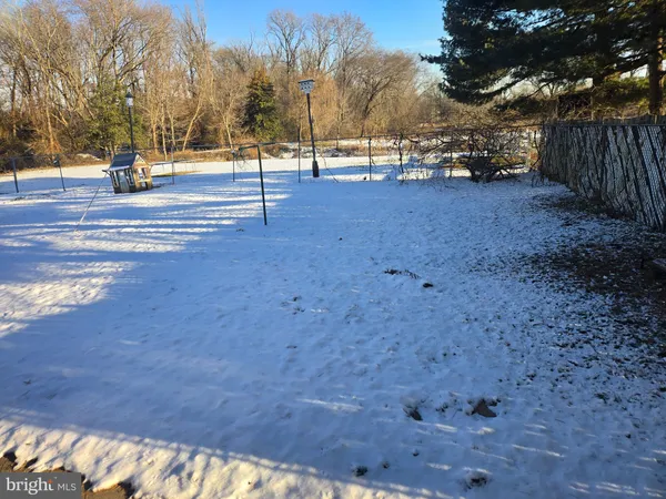 a view of empty space with wooden fence