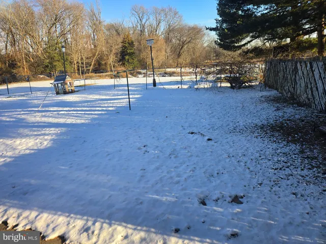 a view of empty space with wooden fence