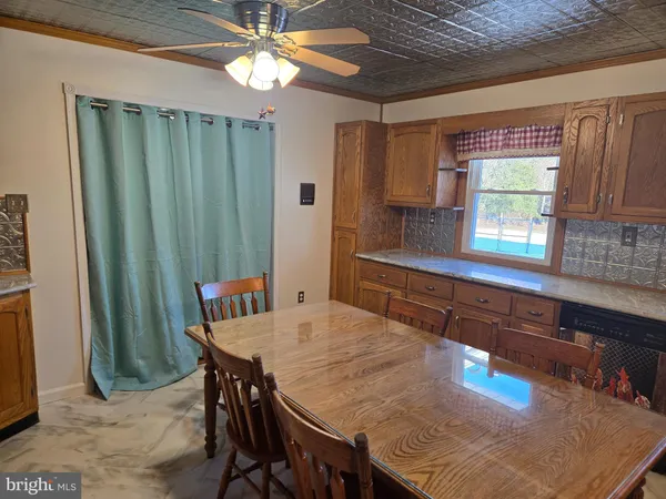 a kitchen with a table chairs and refrigerator
