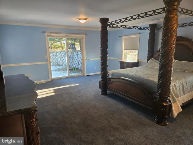 a spacious bedroom with a bed and a window