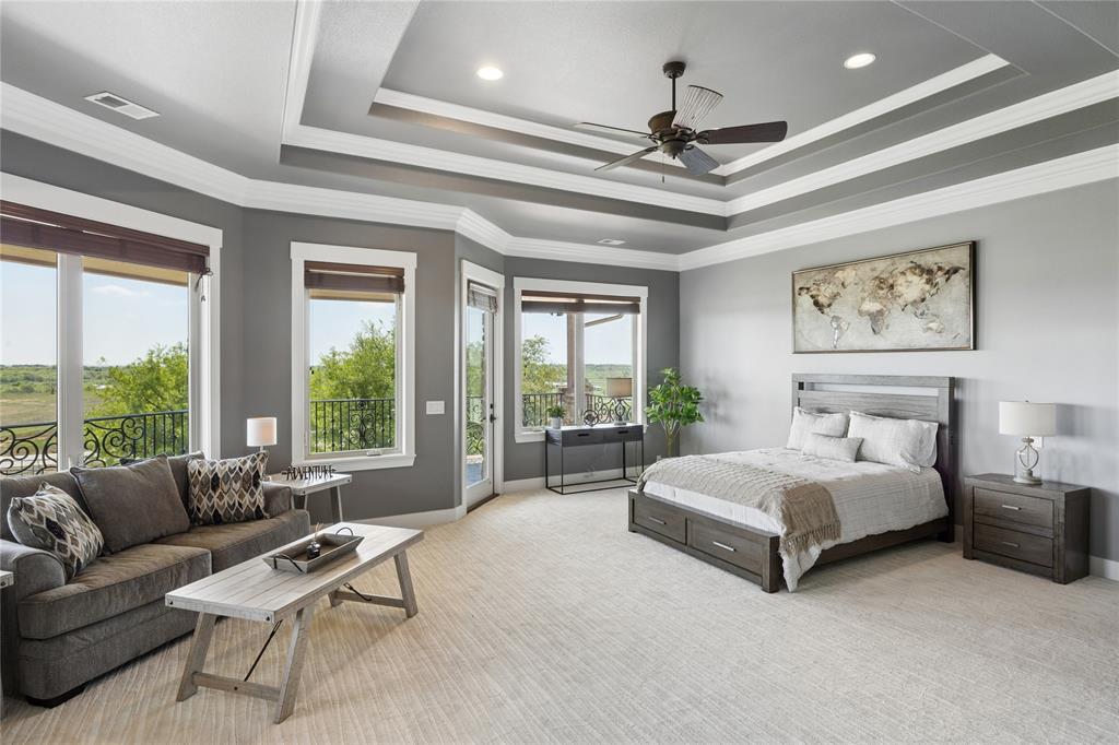 1180 McReynolds Road Sanger, TX 76266 - Photo 23 of 40 Spacious room featuring multiple windows with outdoor access, a tray ceiling with recessed lighting and a ceiling fan, and light-toned carpet flooring