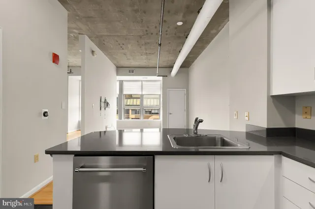 a kitchen with granite countertop a sink and cabinets