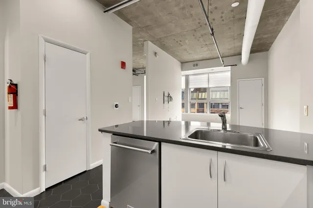 a kitchen with stainless steel appliances granite countertop a sink and a counter space