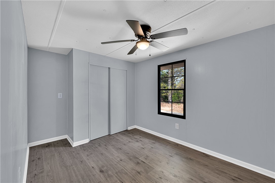 220 Bill Kay Road Belton, SC 29627 - Photo 13 of 30 This bright room features a large window, durable flooring, and a ceiling fan for comfort.