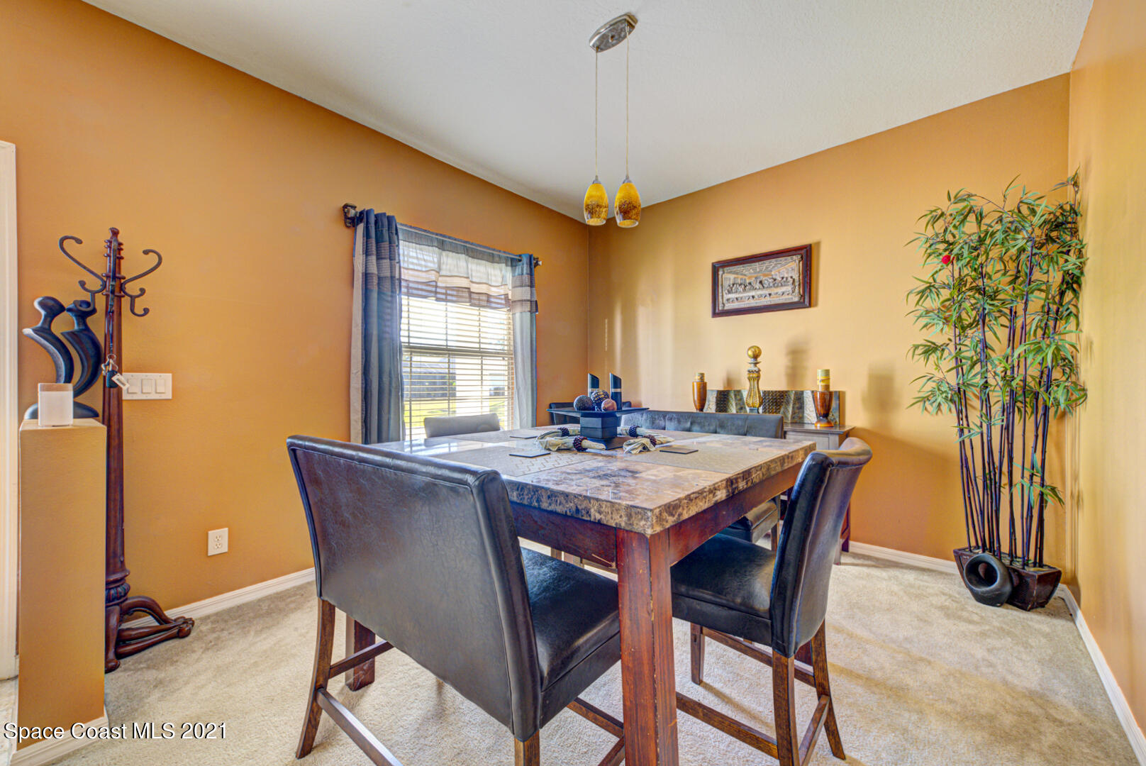 1483 Wakefield Road Southeast Palm Bay, FL 32909 - Photo 11 of 42 a view of a dining room with furniture and a potted plant