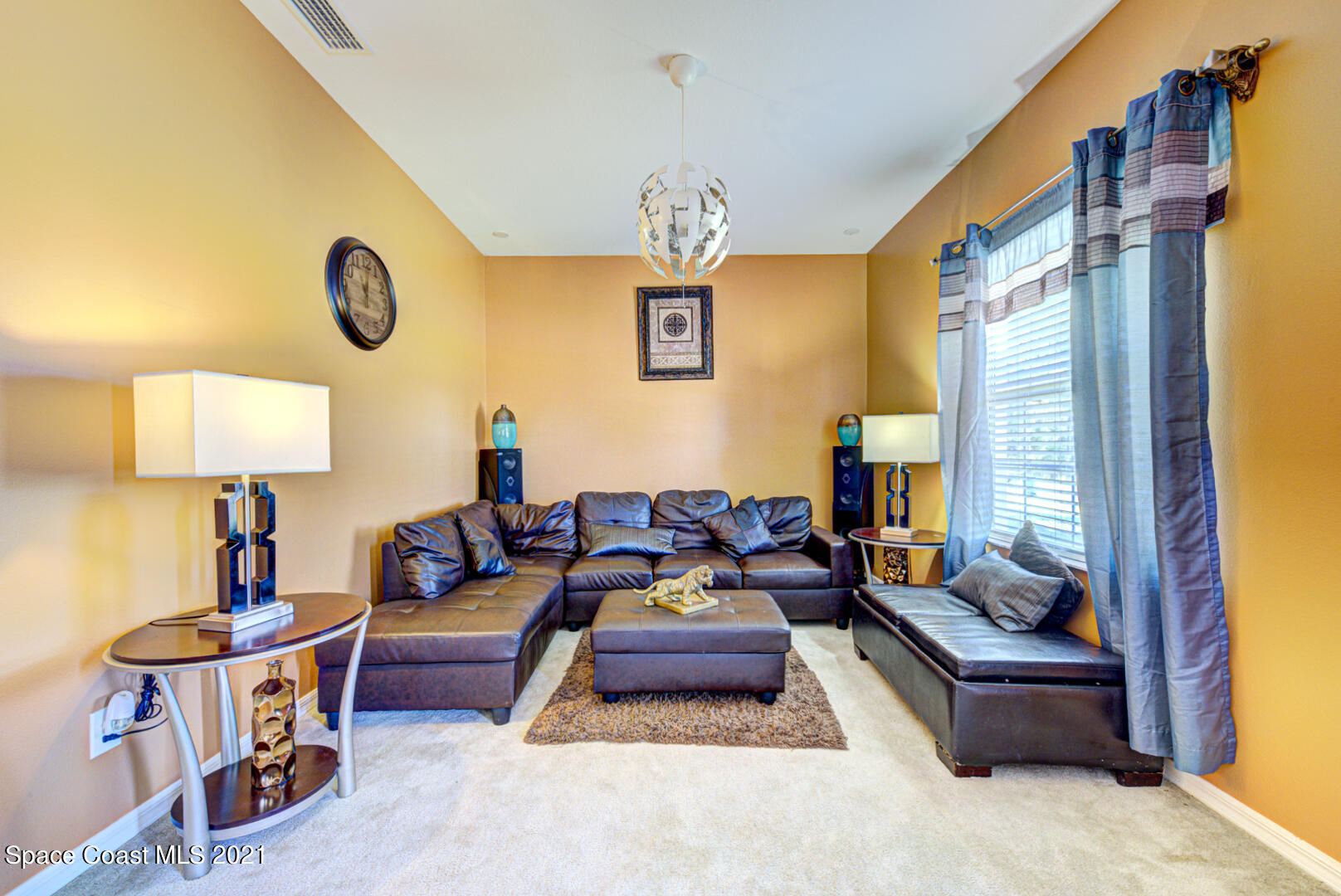 1483 Wakefield Road Southeast Palm Bay, FL 32909 - Photo 13 of 42 a living room with furniture a window and a chandelier