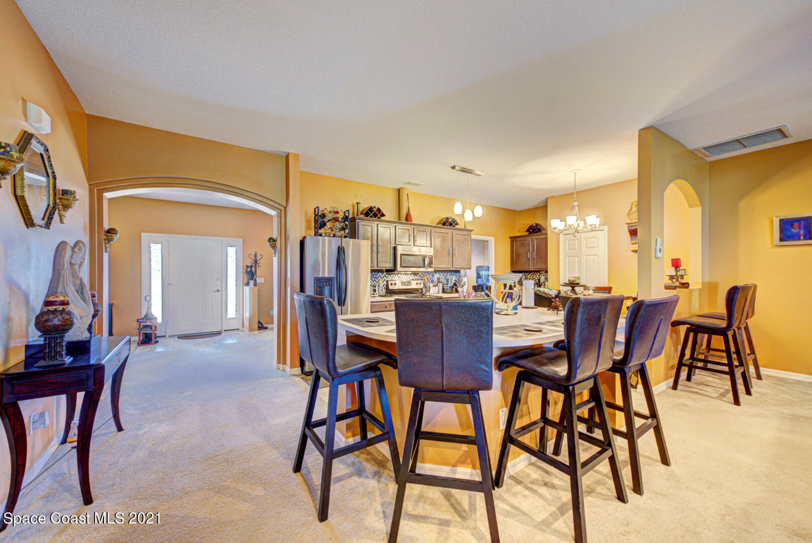 1483 Wakefield Road Southeast Palm Bay, FL 32909 - Photo 14 of 42 a dining room with furniture and a floor to ceiling window