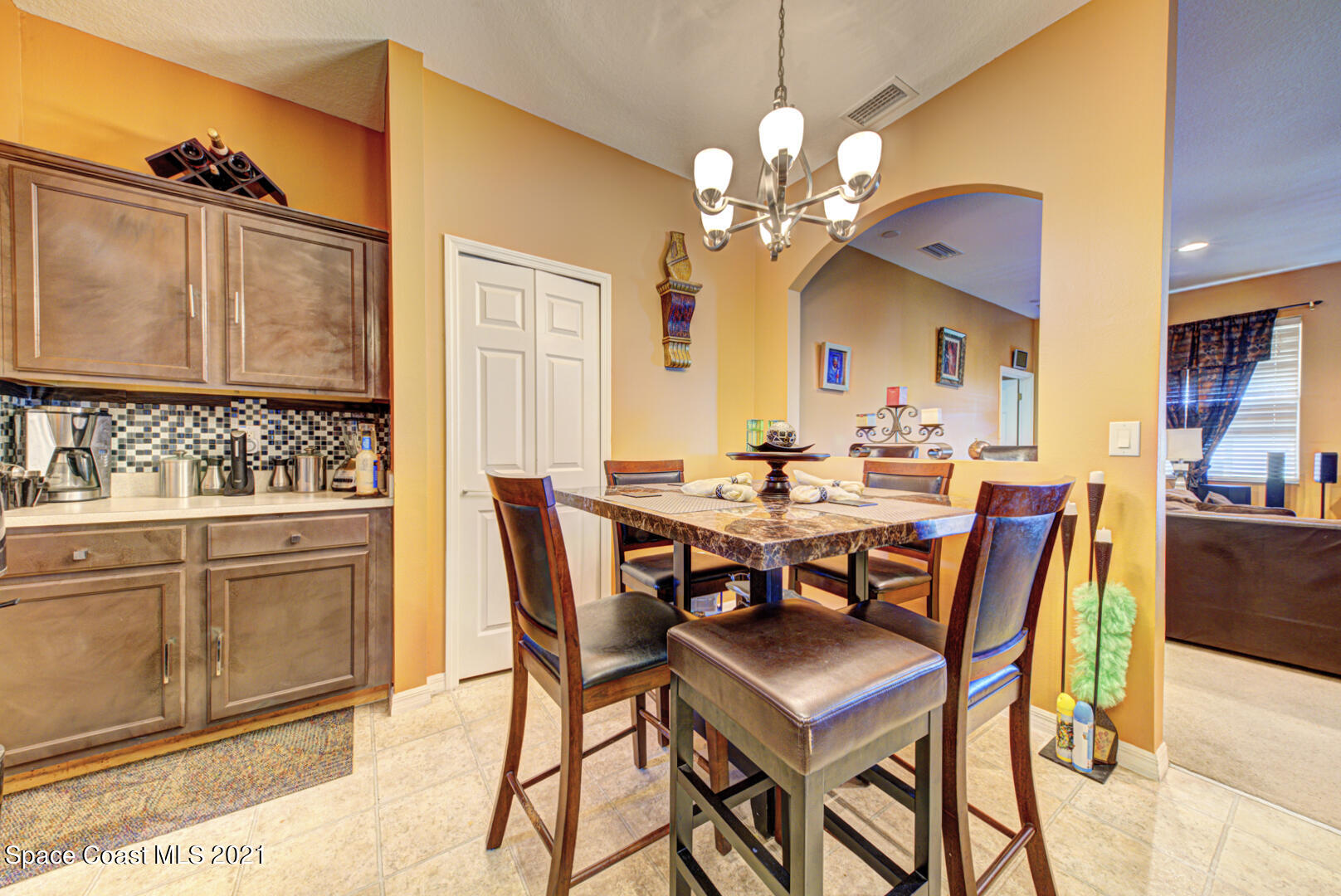 1483 Wakefield Road Southeast Palm Bay, FL 32909 - Photo 15 of 42 a view of a dining room with furniture and chandelier