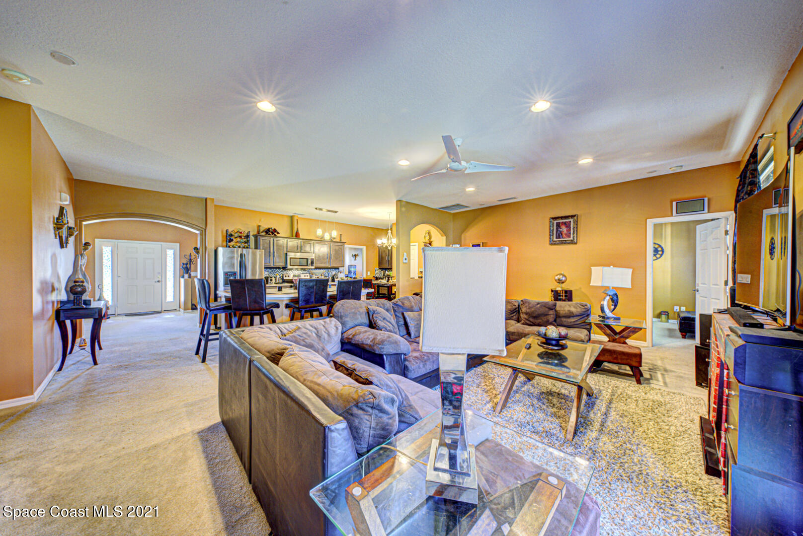 1483 Wakefield Road Southeast Palm Bay, FL 32909 - Photo 16 of 42 a living room with lots of furniture kitchen view and a large window