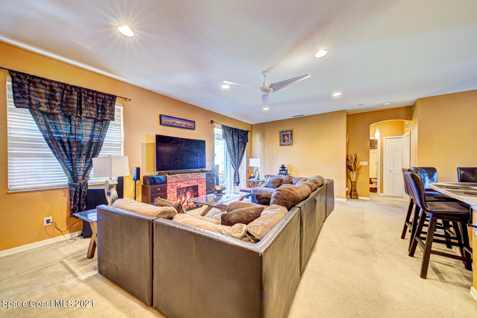 1483 Wakefield Road Southeast Palm Bay, FL 32909 - Photo 17 of 42 a living room with furniture a flat screen tv and a large window