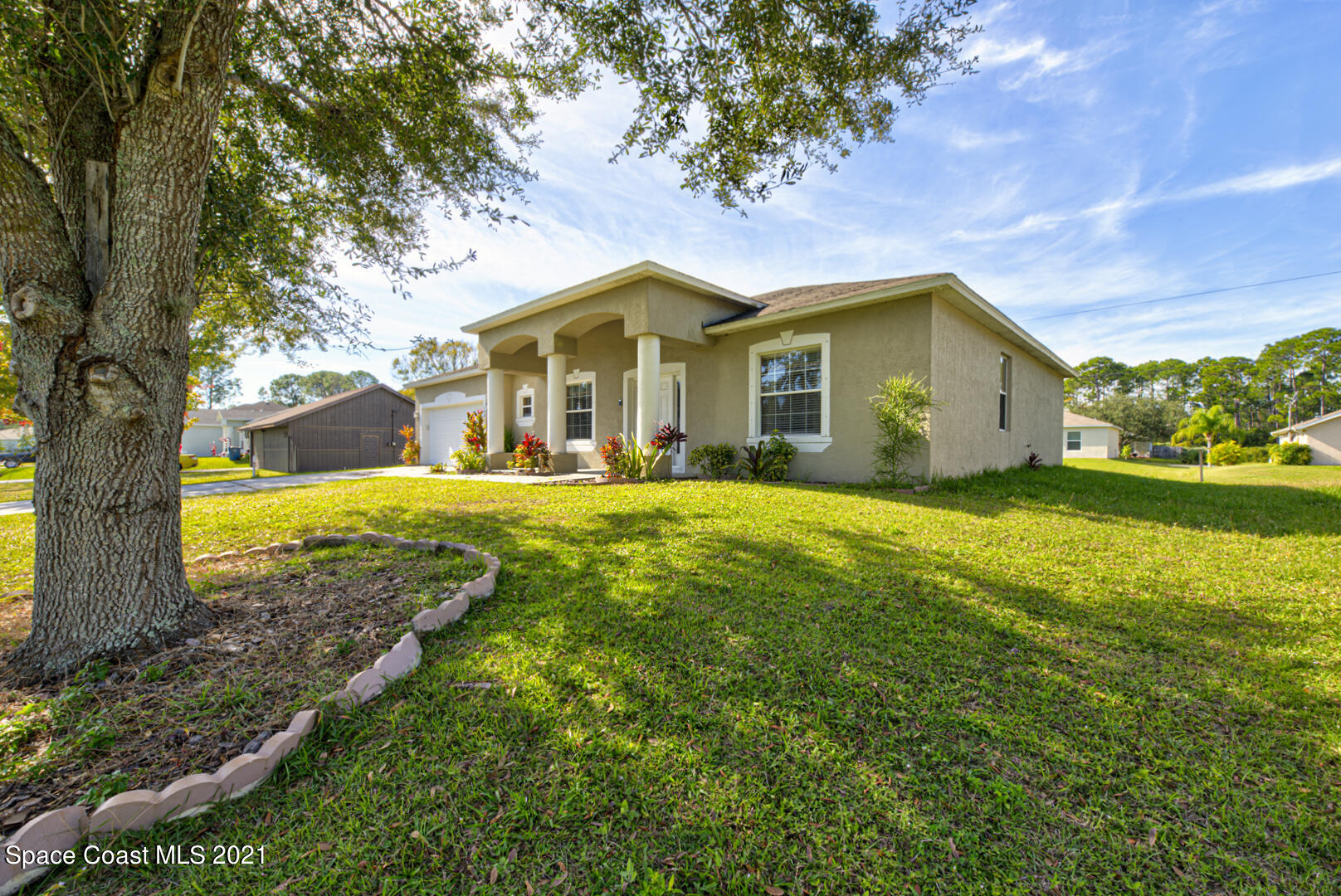 1483 Wakefield Road Southeast Palm Bay, FL 32909 - Photo 3 of 42 a front view of a house with garden