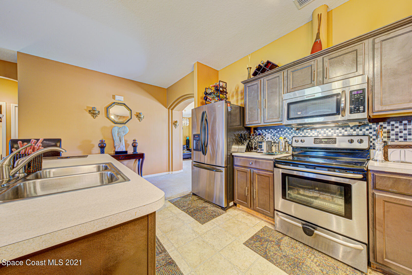1483 Wakefield Road Southeast Palm Bay, FL 32909 - Photo 22 of 42 a kitchen with a sink cabinets and stainless steel appliances