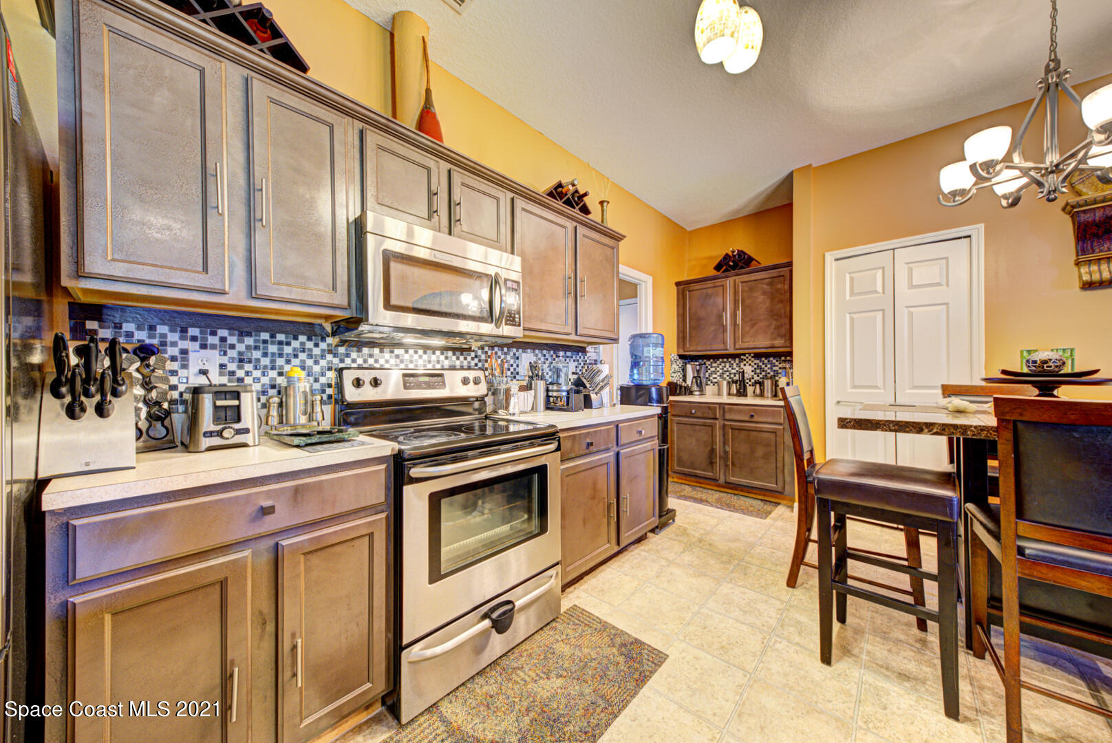 1483 Wakefield Road Southeast Palm Bay, FL 32909 - Photo 23 of 42 a kitchen with stainless steel appliances granite countertop a stove a sink dishwasher and cabinets with wooden floor