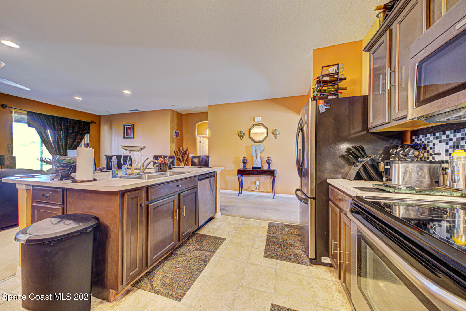1483 Wakefield Road Southeast Palm Bay, FL 32909 - Photo 24 of 42 a kitchen with stainless steel appliances granite countertop a sink and cabinets