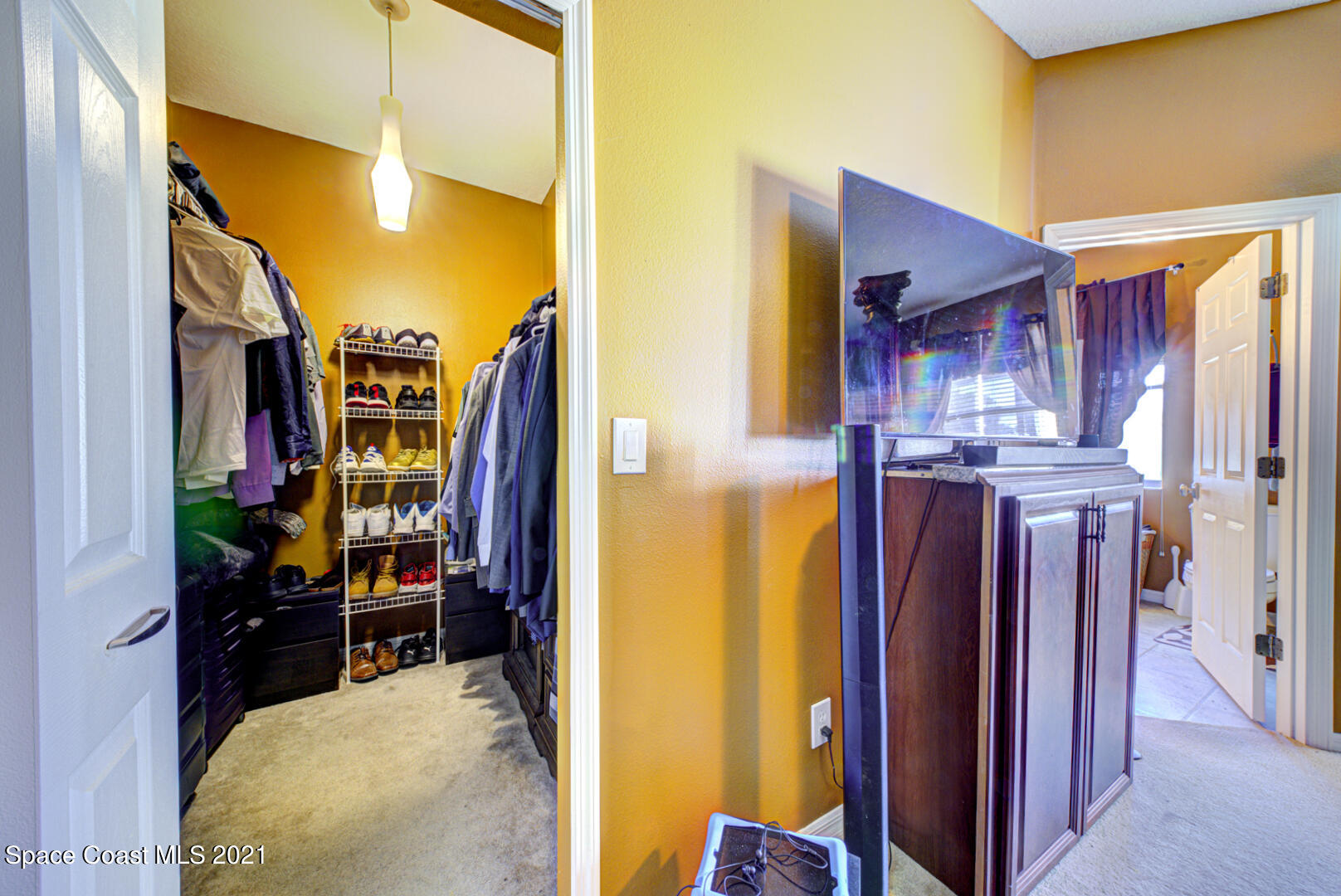 1483 Wakefield Road Southeast Palm Bay, FL 32909 - Photo 30 of 42 a view of walk in closet with clothes and shoes