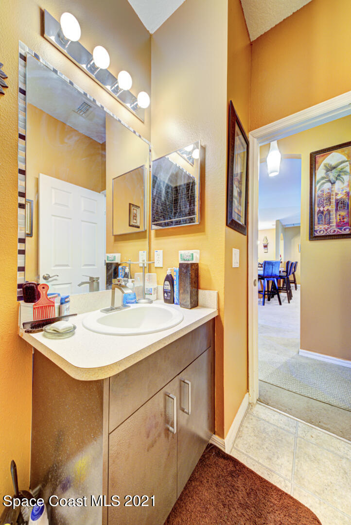 1483 Wakefield Road Southeast Palm Bay, FL 32909 - Photo 33 of 42 a bathroom with a sink a mirror and a shower