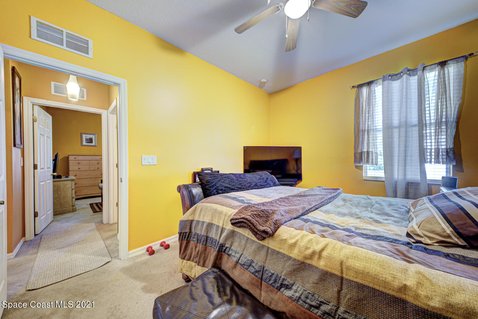 1483 Wakefield Road Southeast Palm Bay, FL 32909 - Photo 36 of 42 a bedroom with a bed and a chandelier
