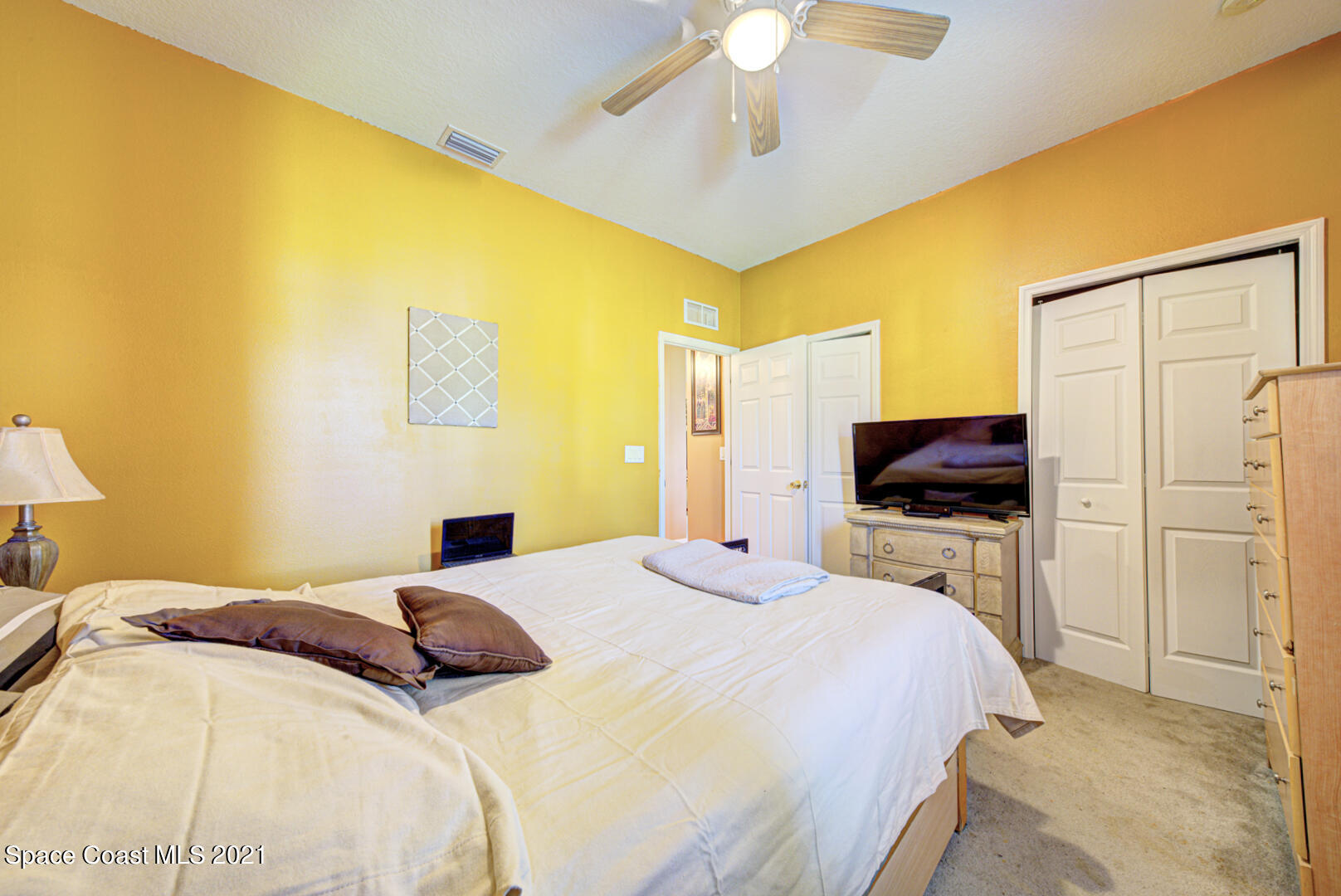 1483 Wakefield Road Southeast Palm Bay, FL 32909 - Photo 39 of 42 a bedroom with a bed and a flat screen tv