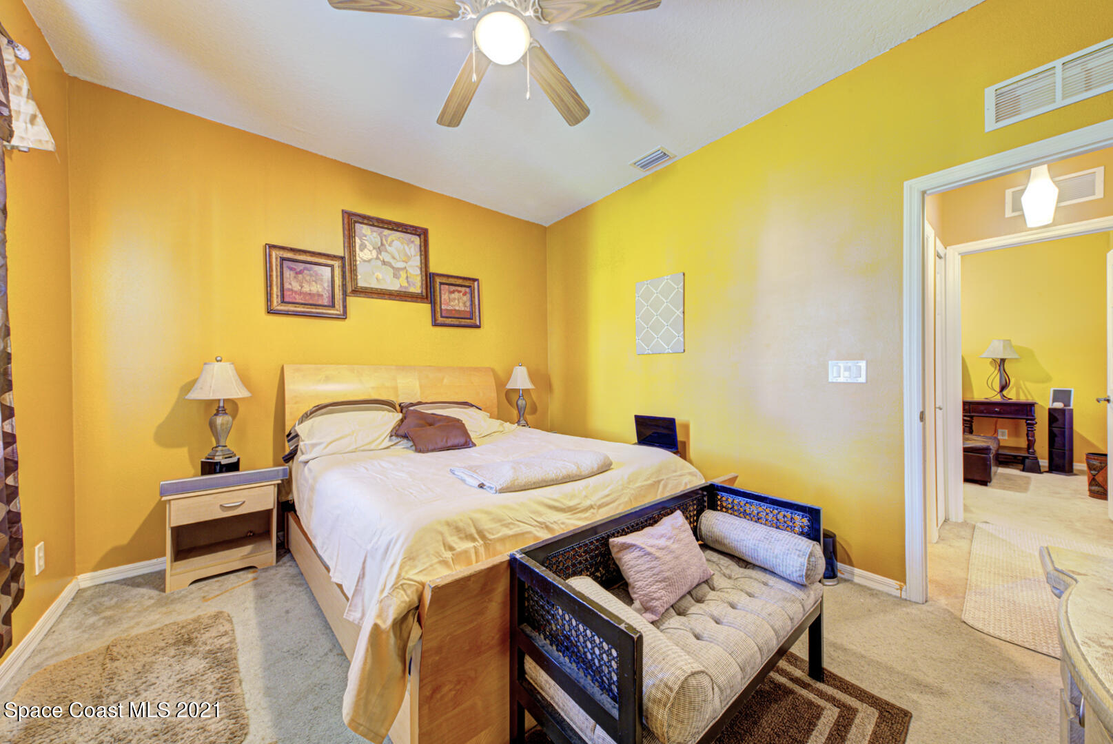 1483 Wakefield Road Southeast Palm Bay, FL 32909 - Photo 40 of 42 a bedroom with a bed and a chandelier
