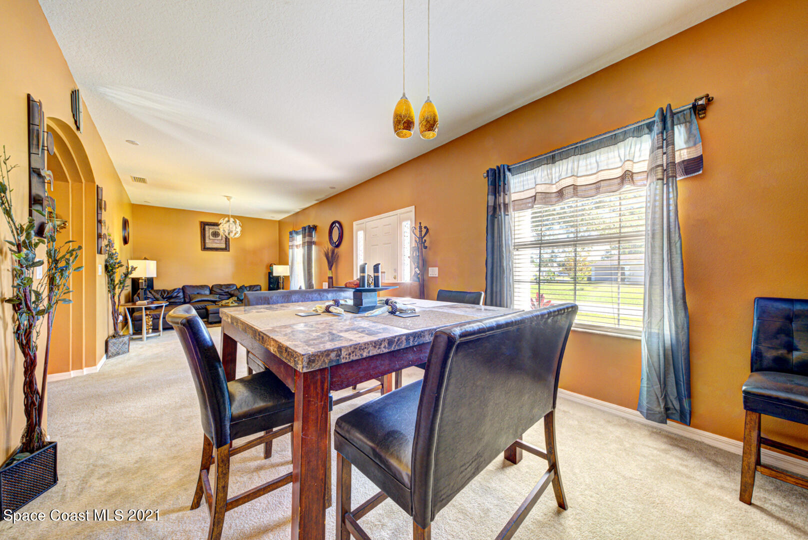 1483 Wakefield Road Southeast Palm Bay, FL 32909 - Photo 10 of 42 a dining room with a table chairs and a kitchen view