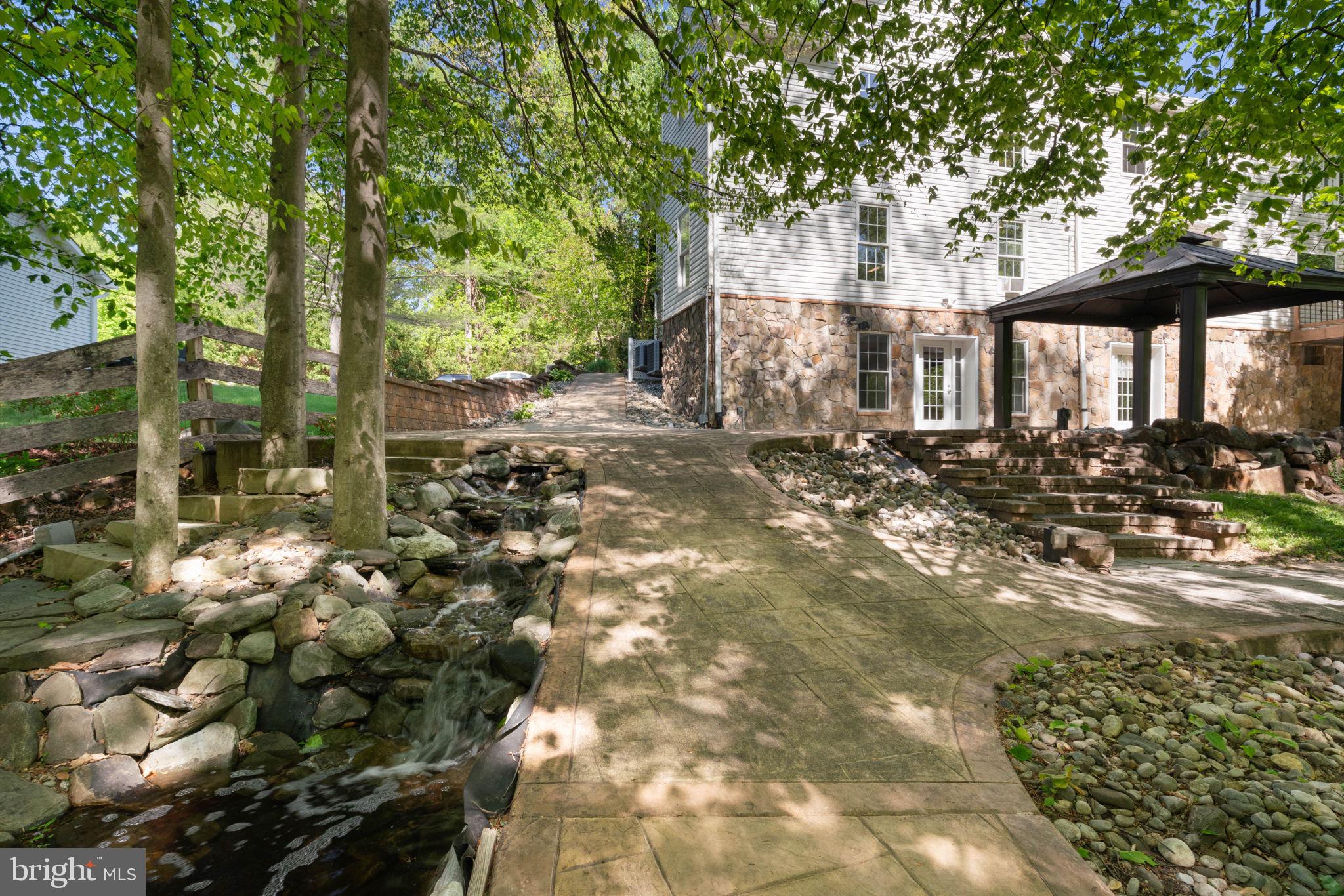 12522 Spring Drive Manassas, VA 20112 - Photo 62 of 69 Serene pathway through lush greenery.
