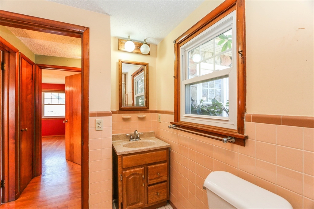 185 East Street Springfield, MA 01104 - Photo 19 of 26 a bathroom with a granite countertop sink mirror and a bathtub