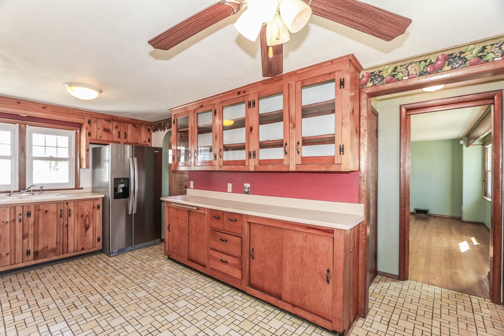 185 East Street Springfield, MA 01104 - Photo 10 of 26 a kitchen with stainless steel appliances kitchen island granite countertop a refrigerator and wooden cabinets
