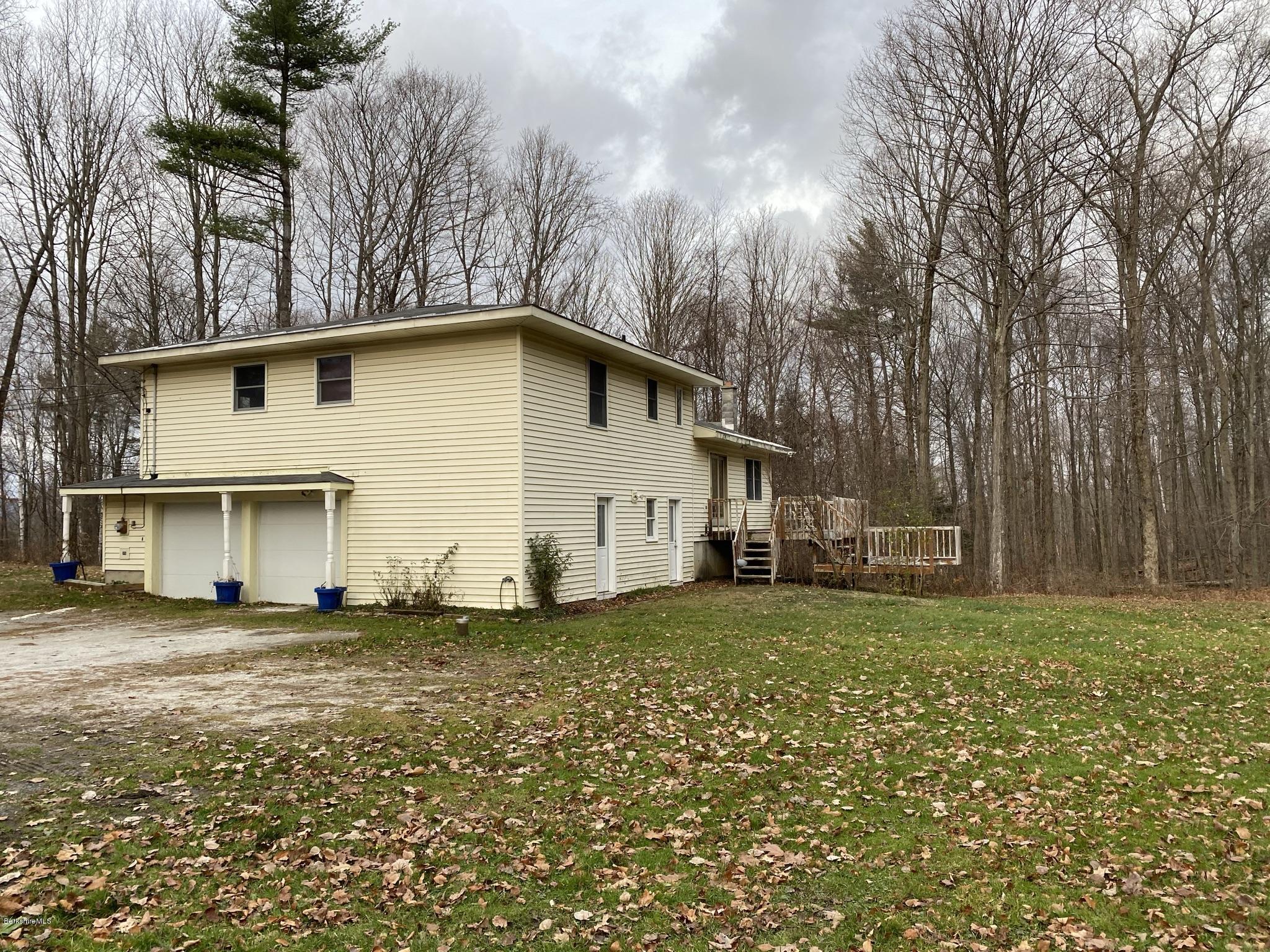 311 Swamp Road Richmond, MA 01201 - Photo 12 of 42 a house that has a big yard and large trees