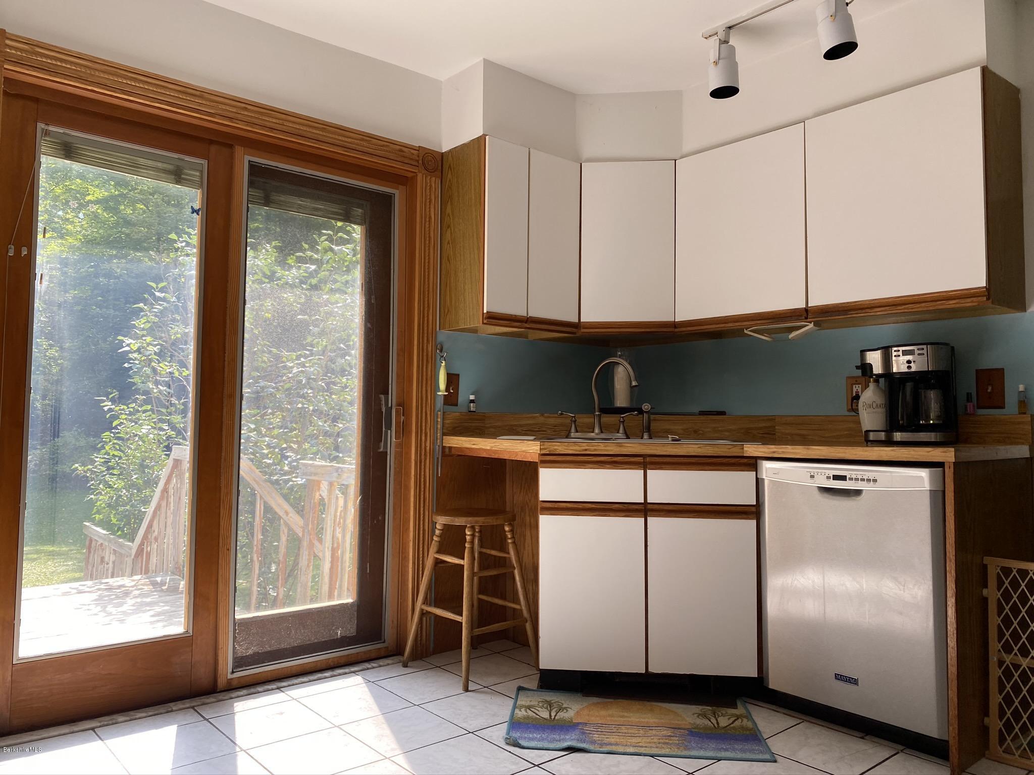 311 Swamp Road Richmond, MA 01201 - Photo 20 of 42 a kitchen with stainless steel appliances granite countertop a refrigerator and a sink