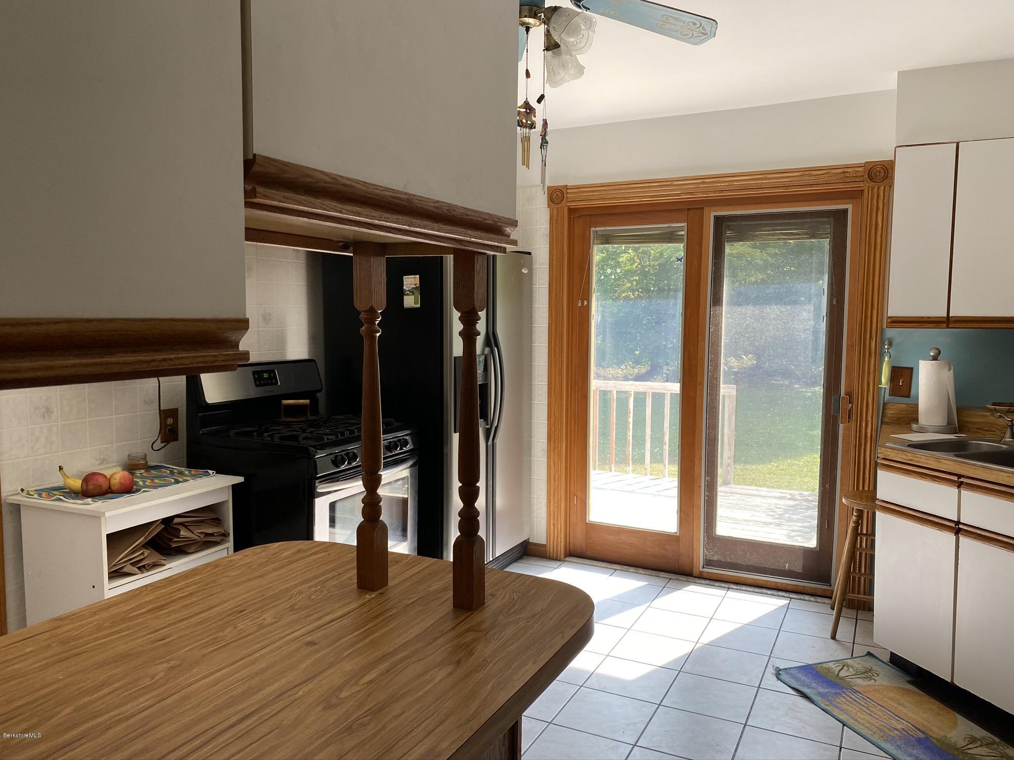 311 Swamp Road Richmond, MA 01201 - Photo 22 of 42 a kitchen with granite countertop a refrigerator a stove and a sink