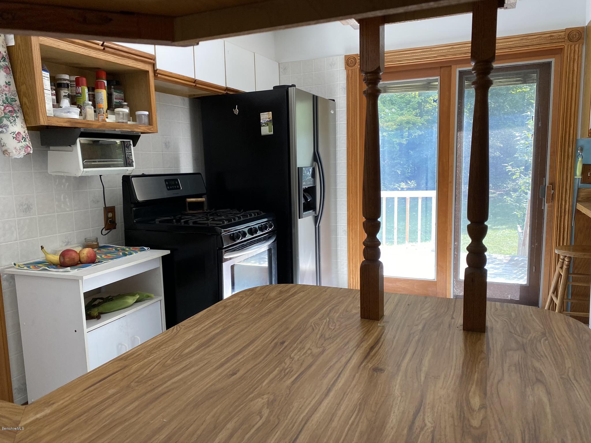 311 Swamp Road Richmond, MA 01201 - Photo 23 of 42 a kitchen with stainless steel appliances a stove and a refrigerator