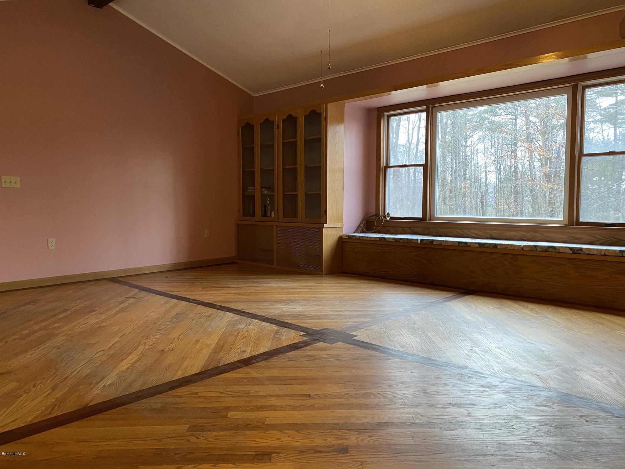 311 Swamp Road Richmond, MA 01201 - Photo 28 of 42 an empty room with wooden floor and windows