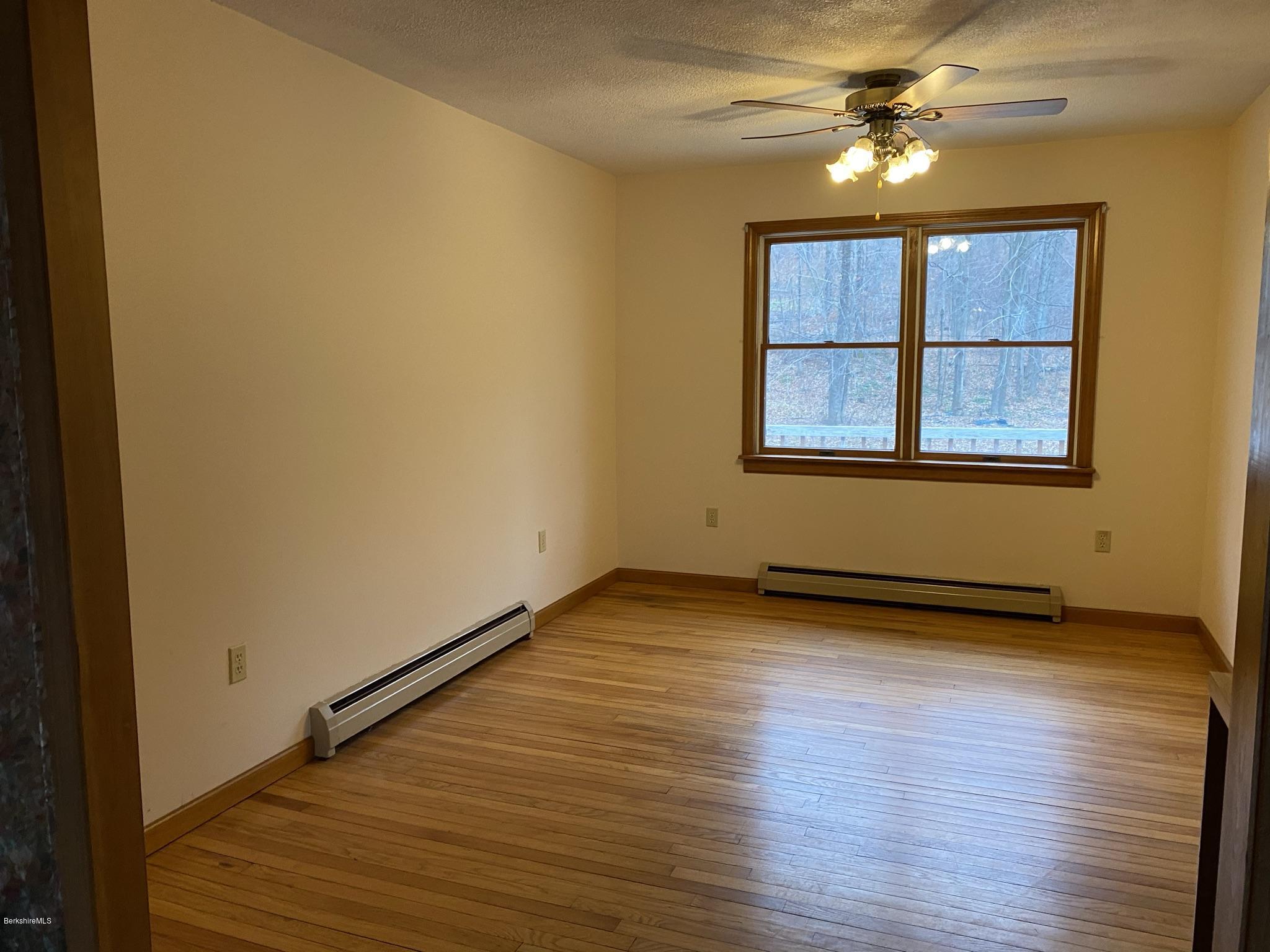 311 Swamp Road Richmond, MA 01201 - Photo 31 of 42 a view of an empty room with wooden floor and a window