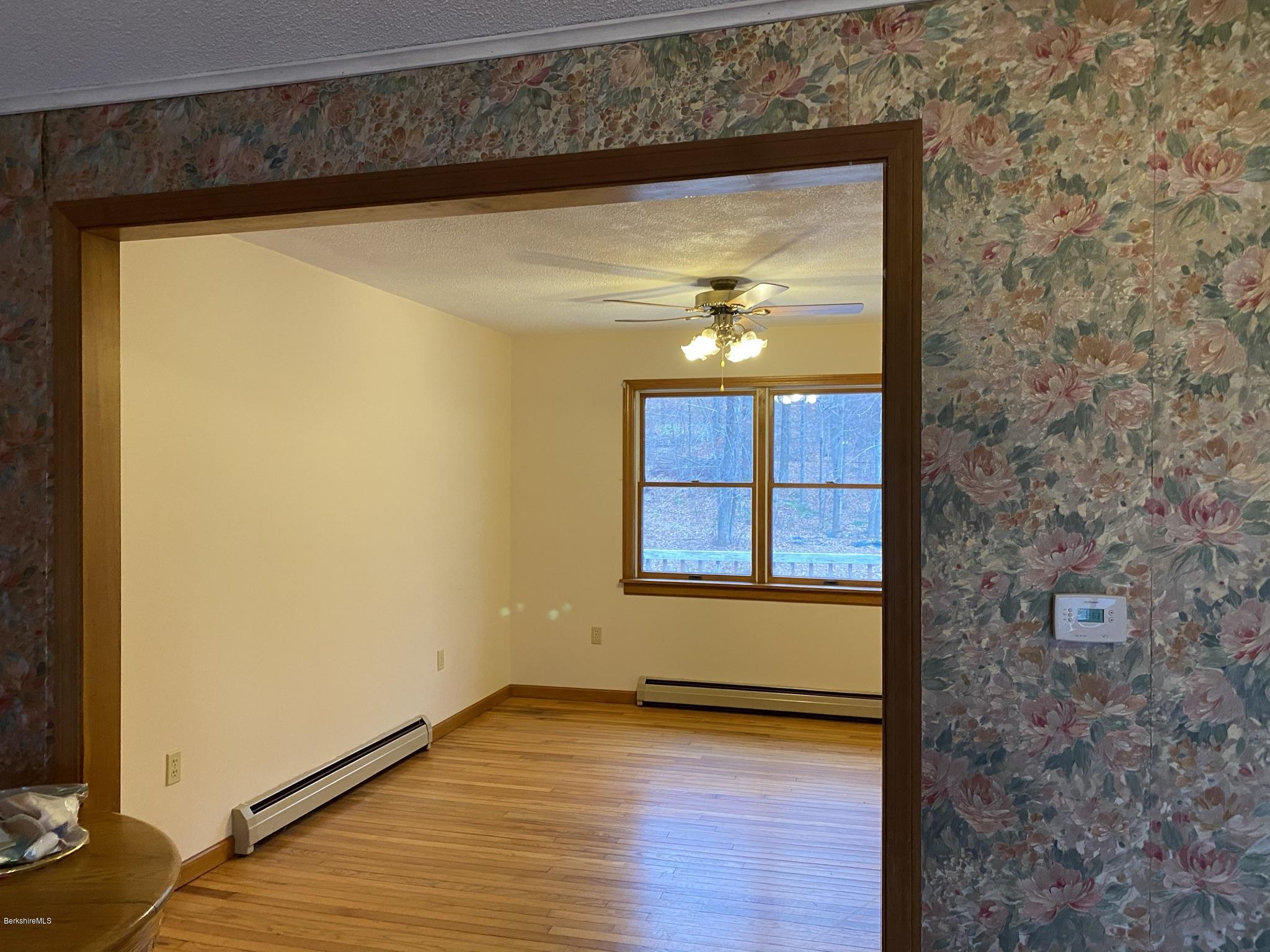 311 Swamp Road Richmond, MA 01201 - Photo 32 of 42 a view of an empty room with wooden floor and a window