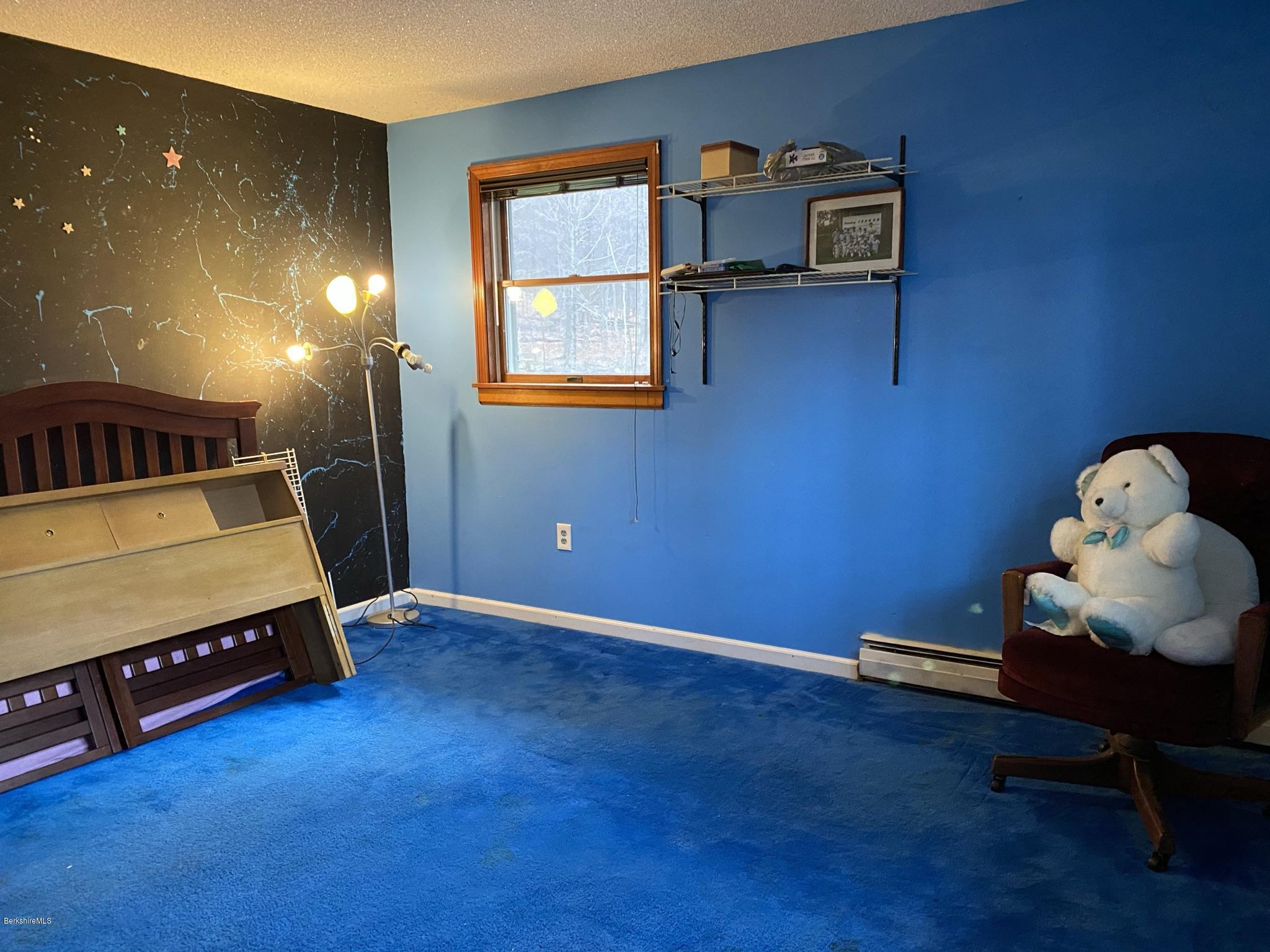 311 Swamp Road Richmond, MA 01201 - Photo 38 of 42 a room with furniture and a flat screen tv
