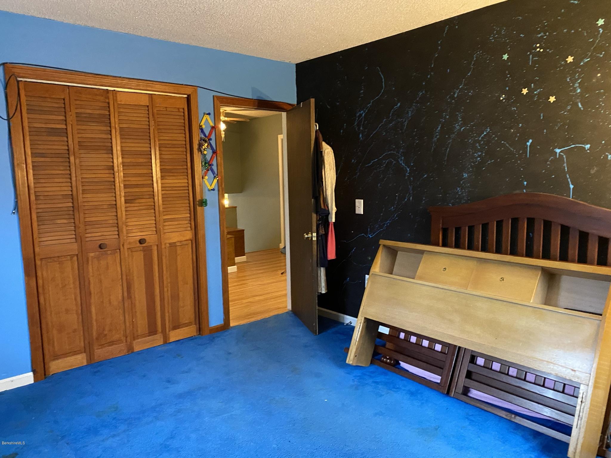 311 Swamp Road Richmond, MA 01201 - Photo 39 of 42 a bedroom with a bed and wooden floor