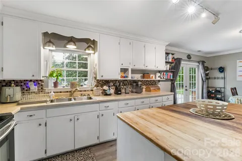 a kitchen with a sink stove and cabinets