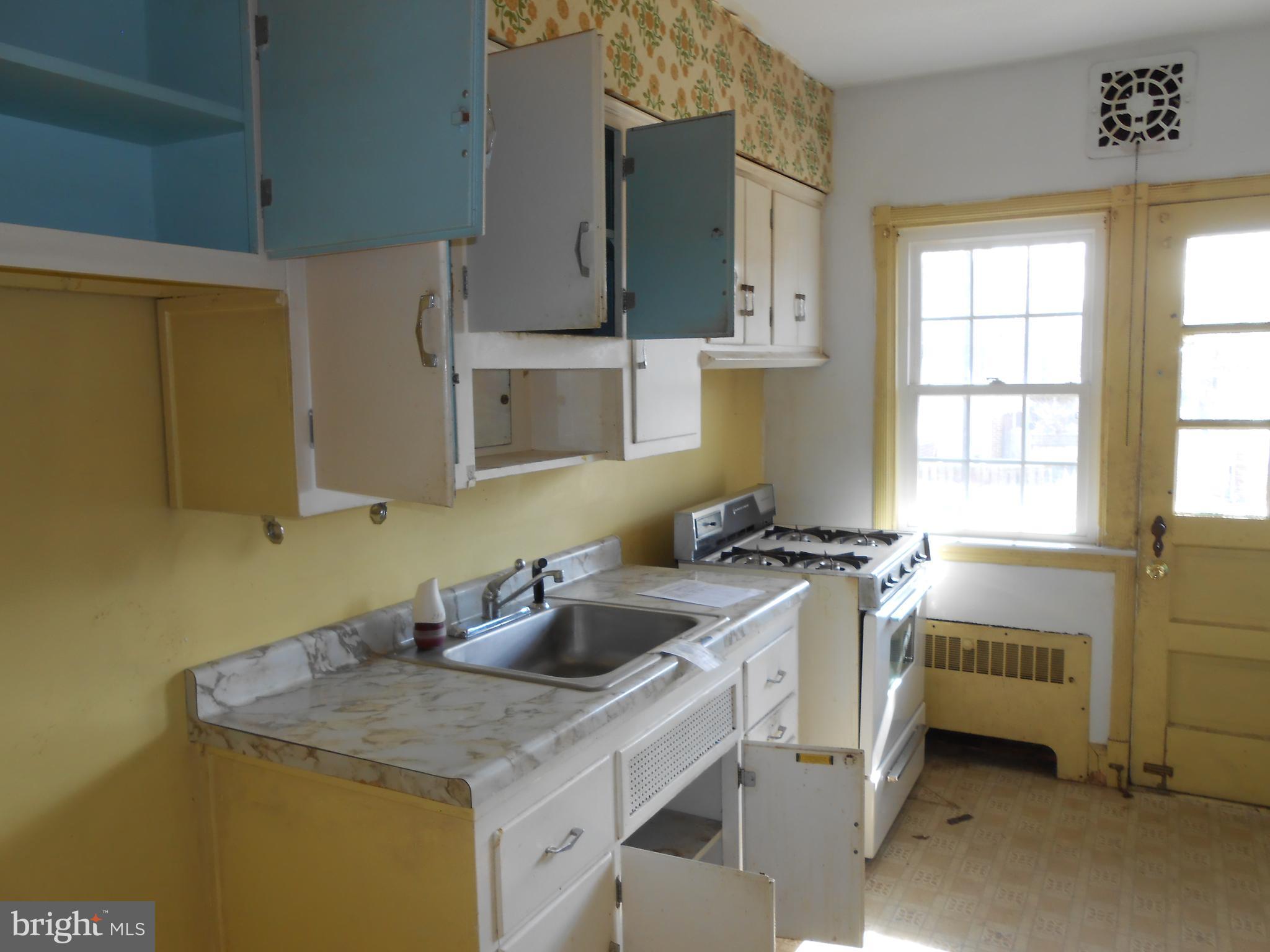 411 Dumbarton Road Baltimore, MD 21212 - Photo 24 of 25 a kitchen with stainless steel appliances a sink stove and cabinets
