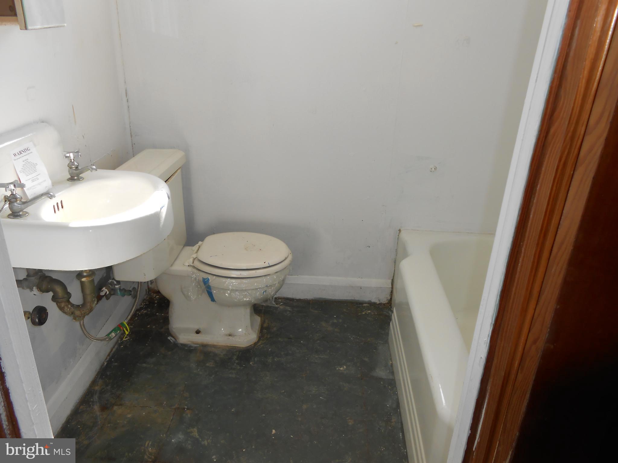 411 Dumbarton Road Baltimore, MD 21212 - Photo 25 of 25 a white toilet sitting next to a white sink